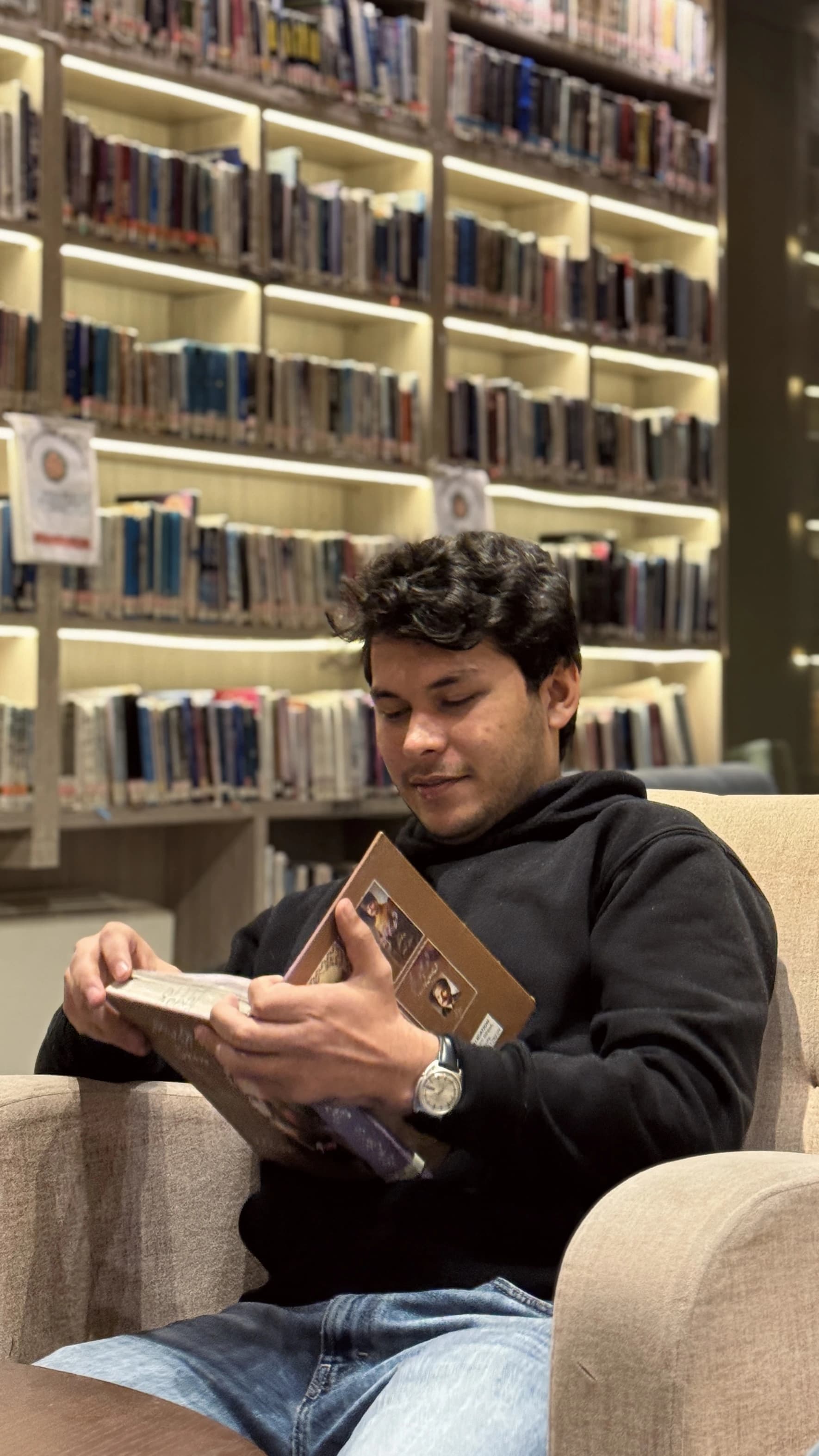 Hasnain Ahmed Khan reading in a library